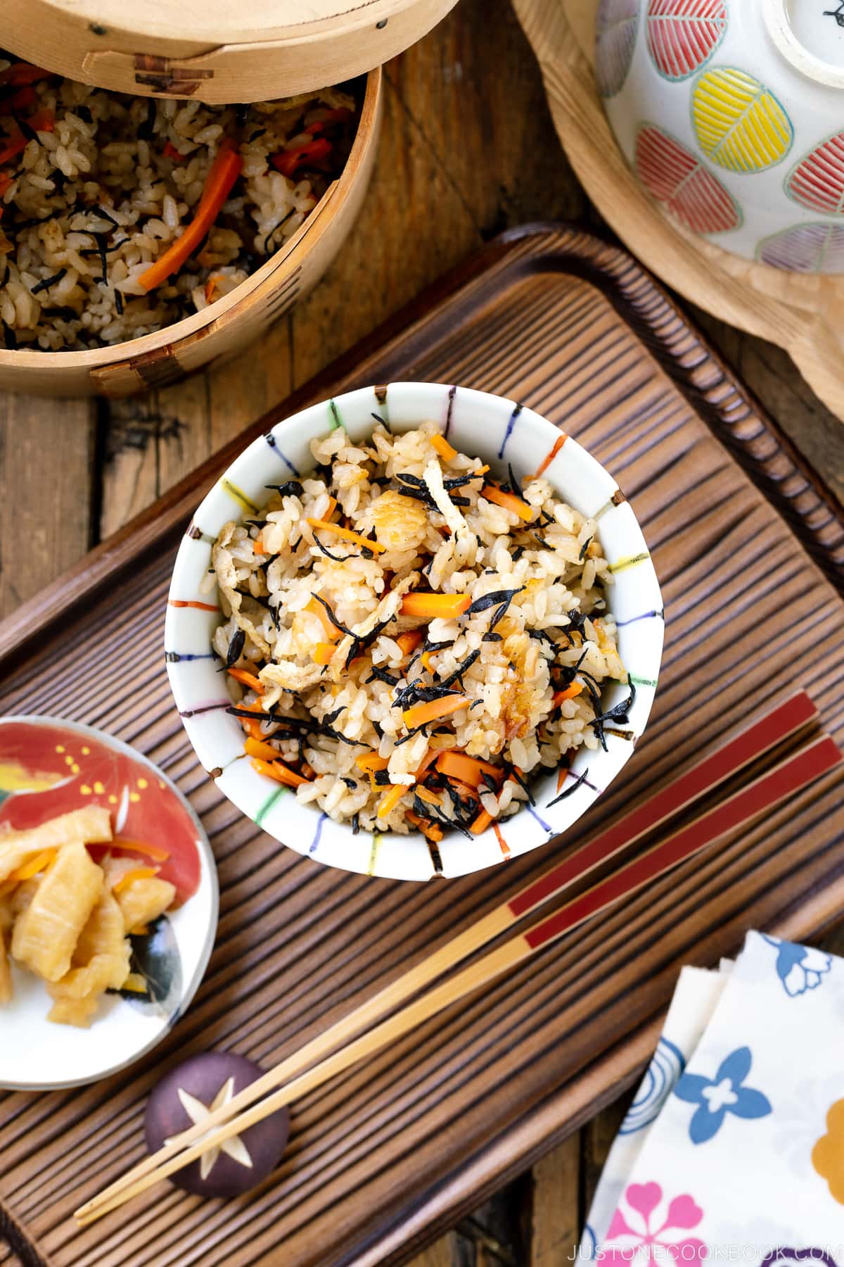 A rice bowl containing Hijiki Rice (Takikomi Gohan) served with pickles on the side.