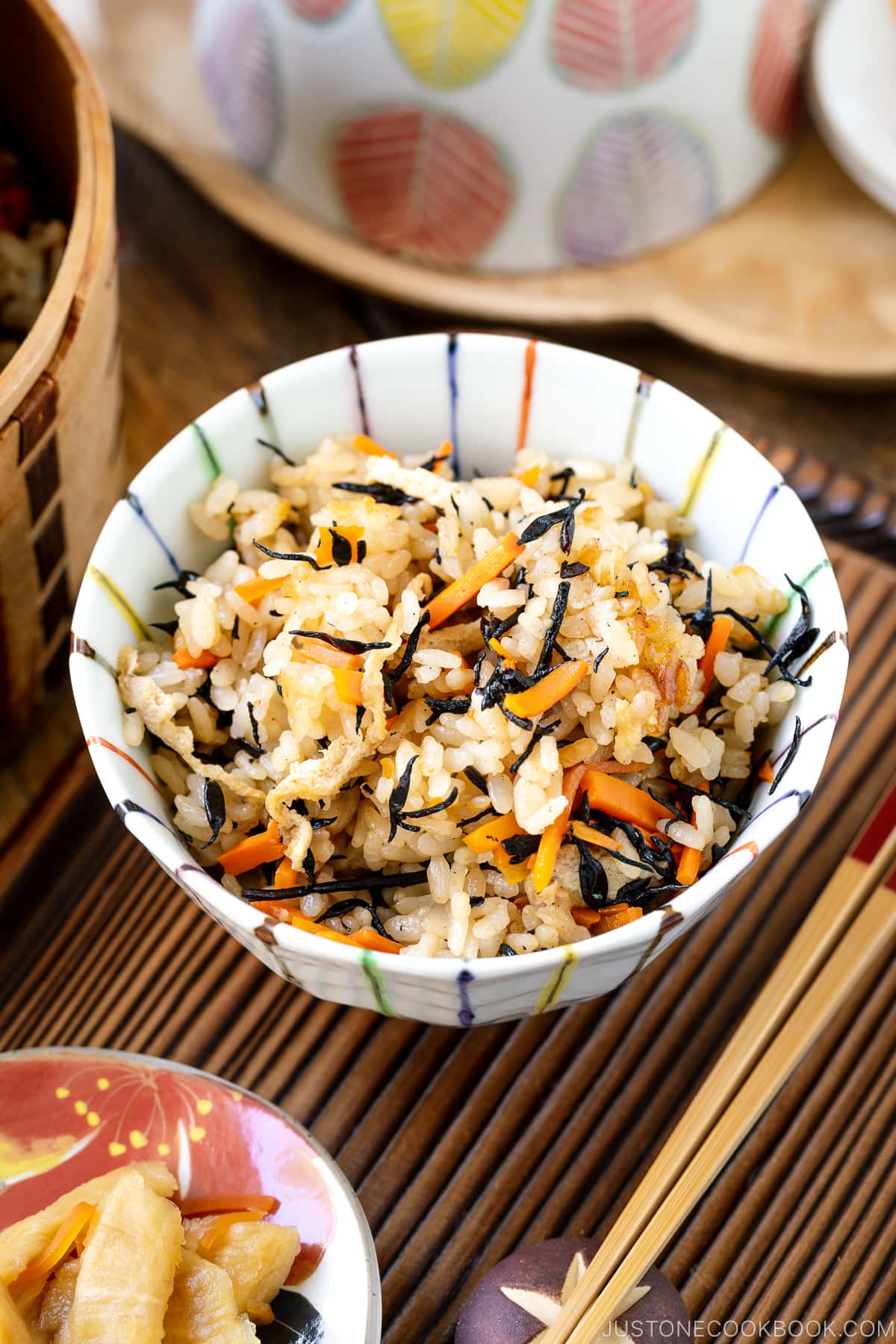 A rice bowl containing Hijiki Rice (Takikomi Gohan) served with pickles on the side.