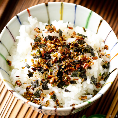 A rice bowl containing steamed rice sprinkled with furikake rice seasoning.