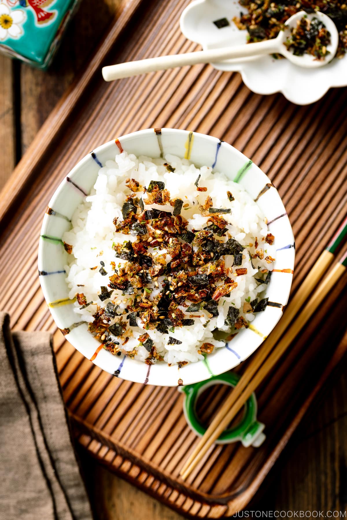 A rice bowl containing steamed rice sprinkled with furikake rice seasoning.