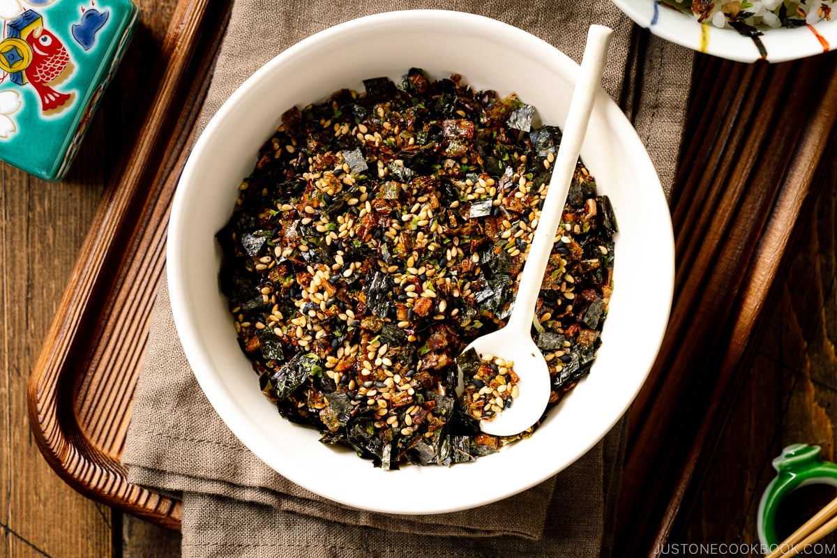 A white round ceramic bowl containing Furikake (Japanese Rice Seasoning).