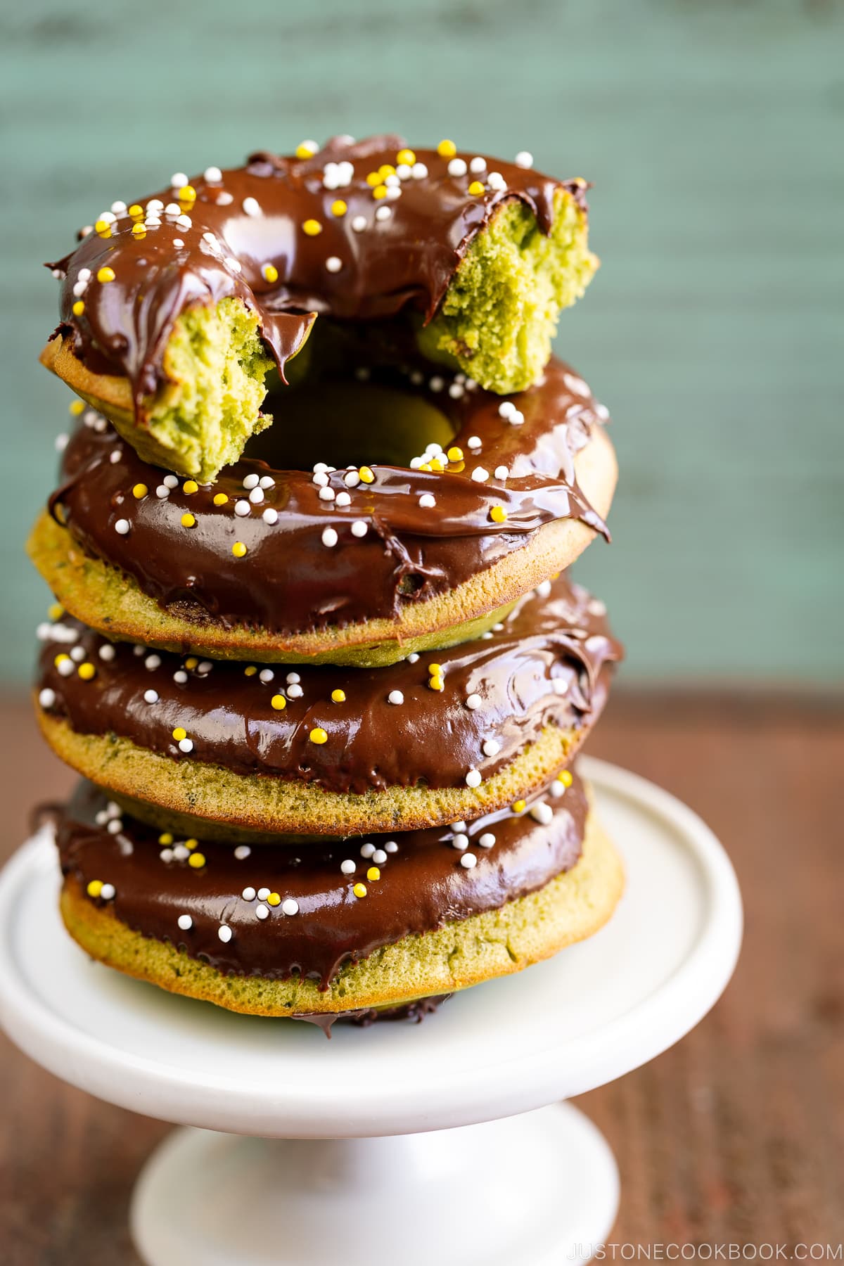 Matcha donuts stack on top of each other.