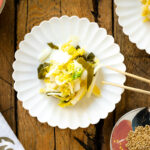 A white ceramic plate containing Napa Cabbage Pickles (Tsukemono).