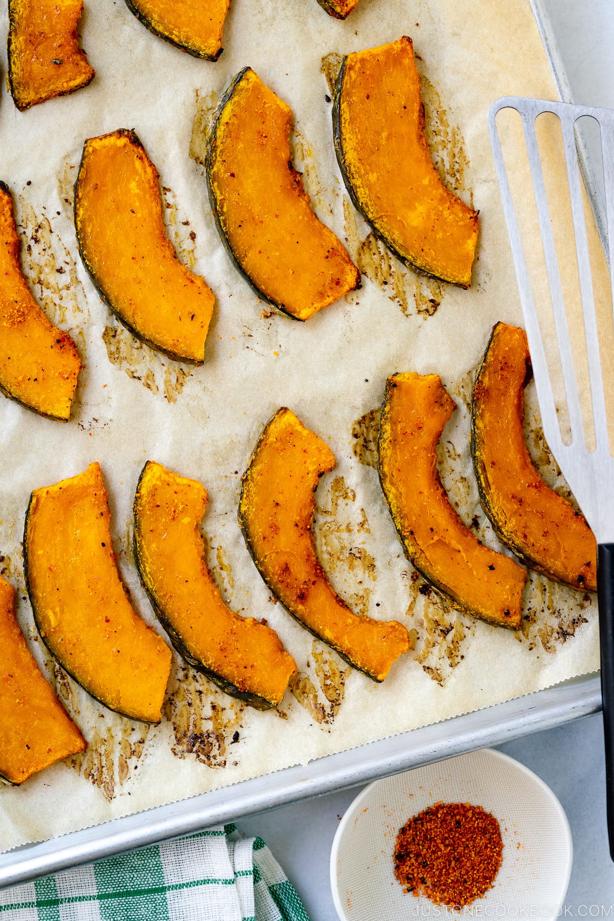 A baking sheet containing roasted kabocha slices.