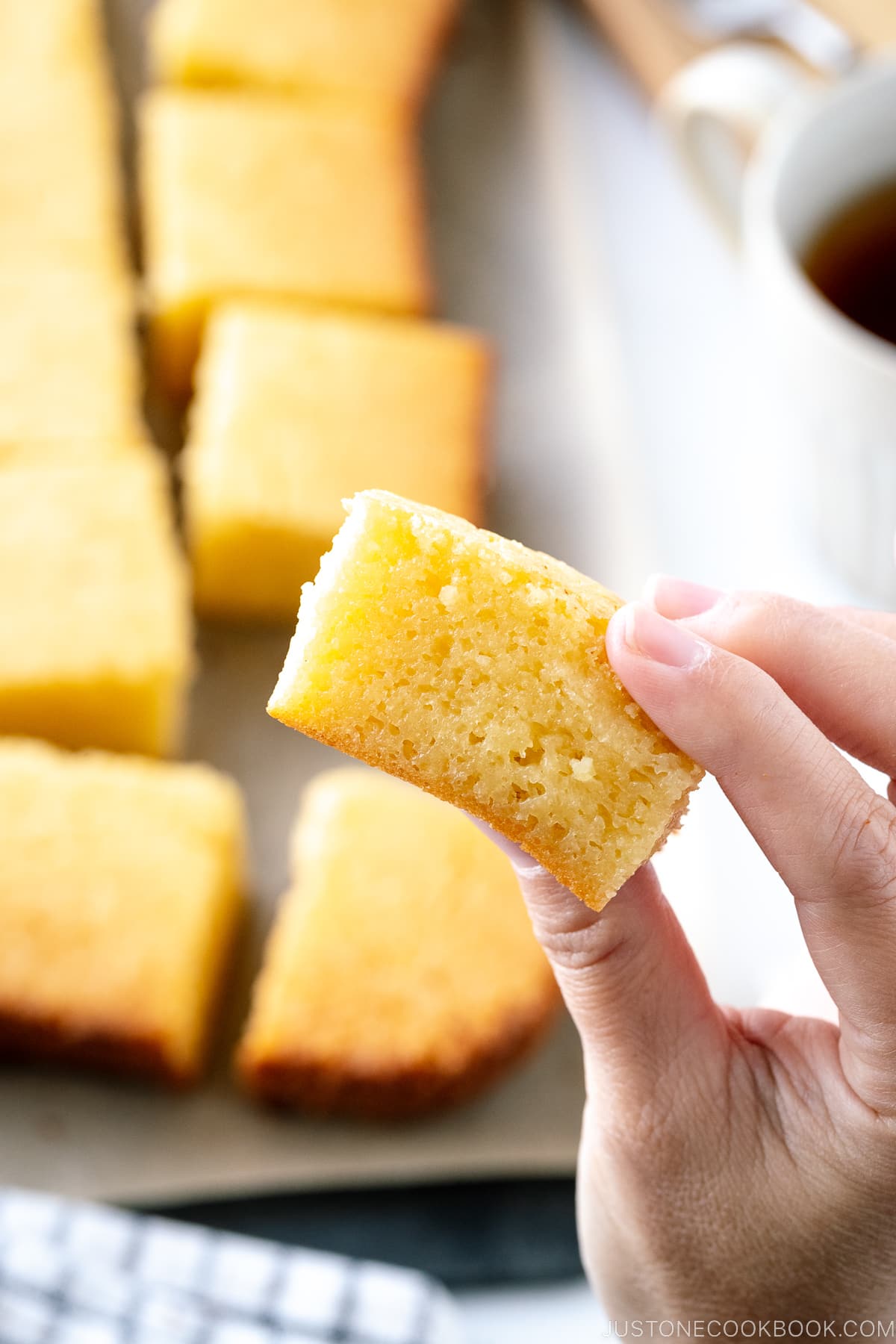 Butter mochi between fingers.