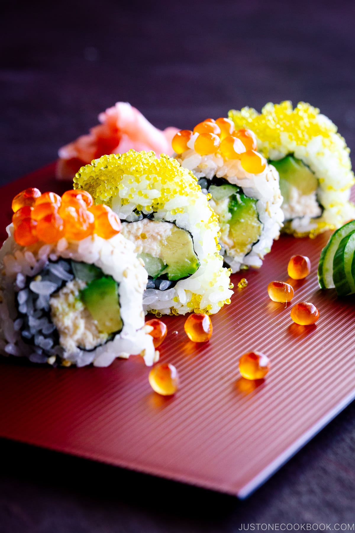 Traditional delicious fresh sushi roll set on a black background