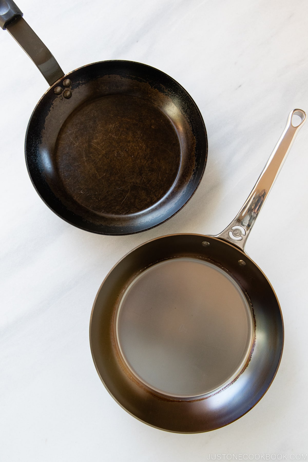 newly seasoned and well used carbon steel fry pan