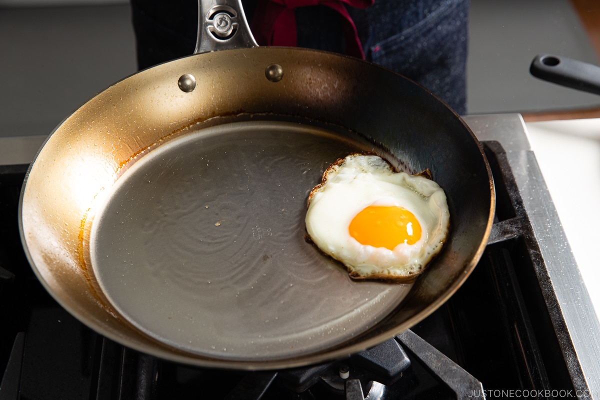 egg sliding on fry pan