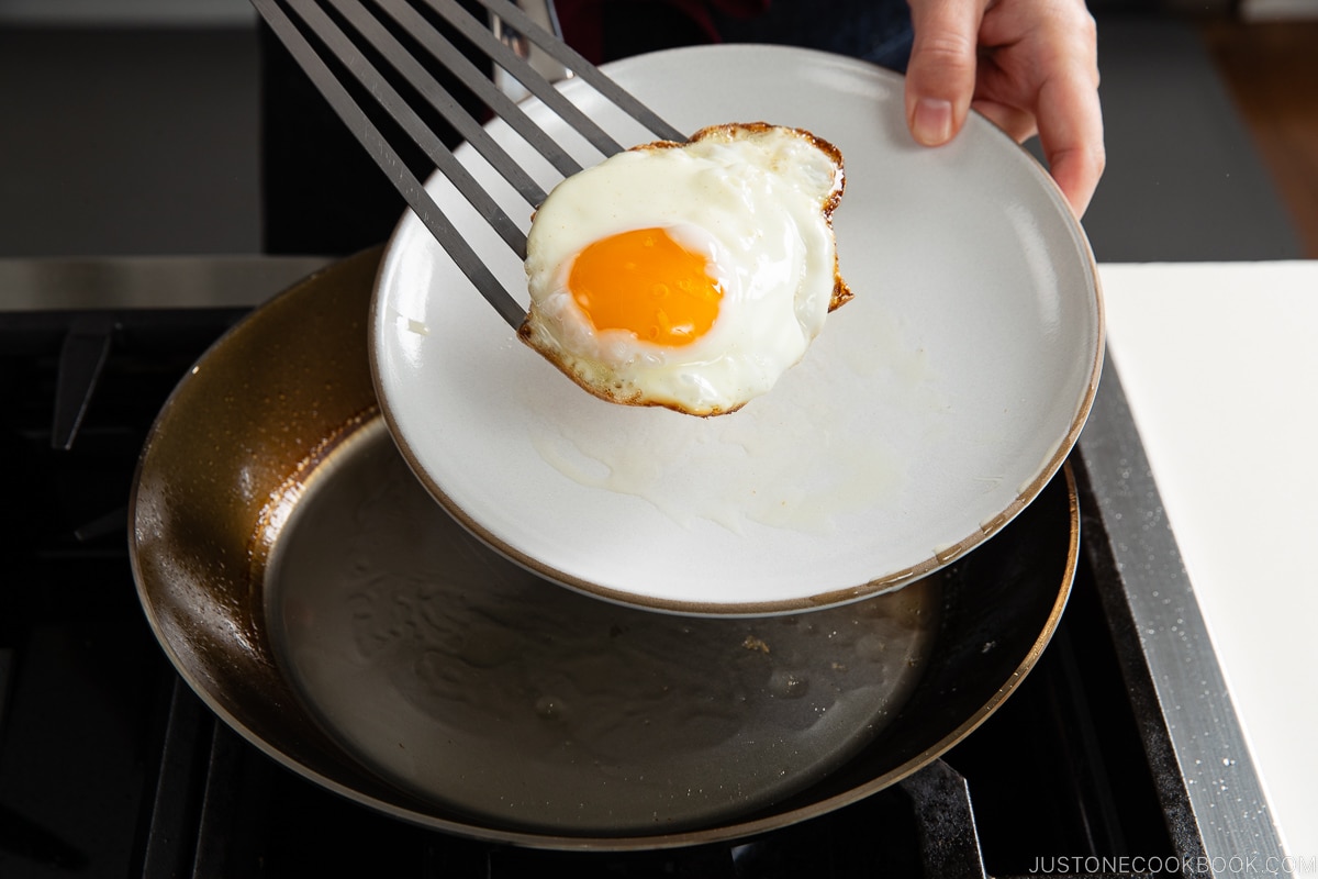 egg on a spatula on top of a dish
