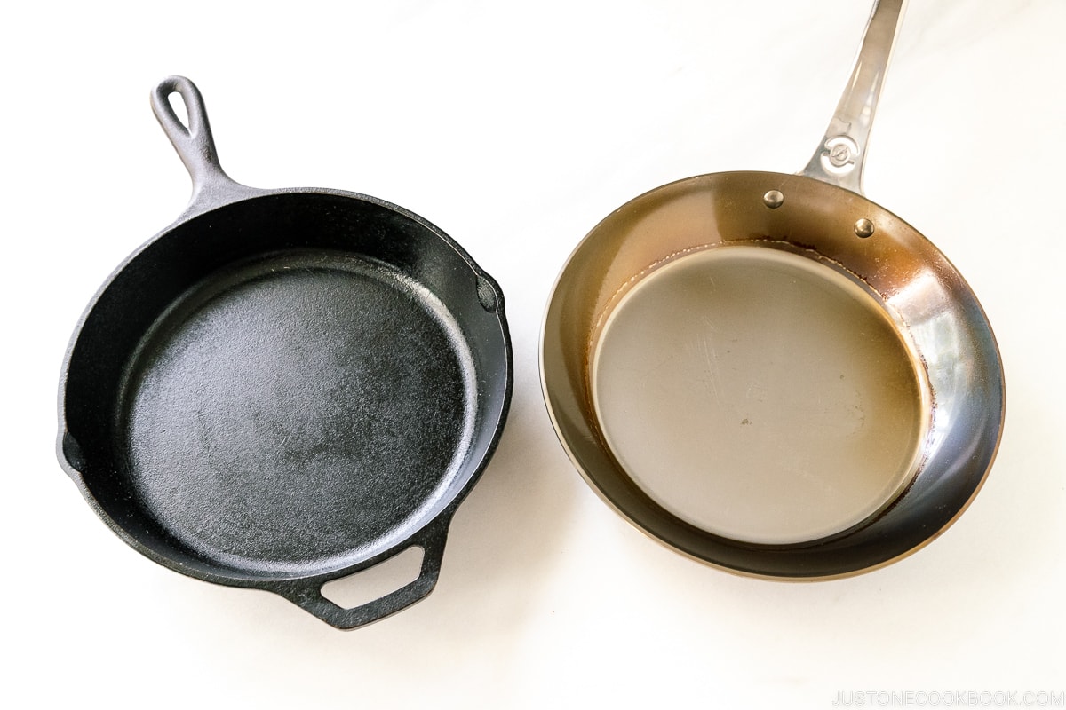 a cast iron pan and a carbon steel pan