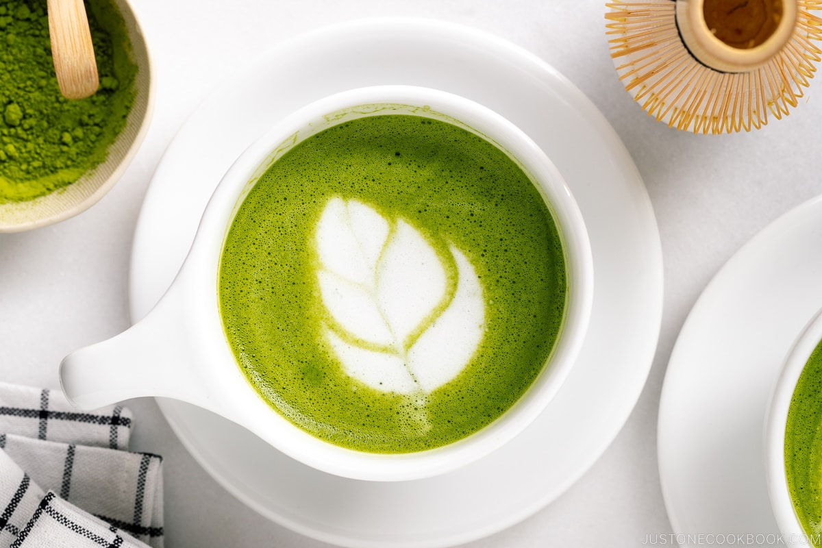 White cups containing Matcha Latte with a turip latte art.