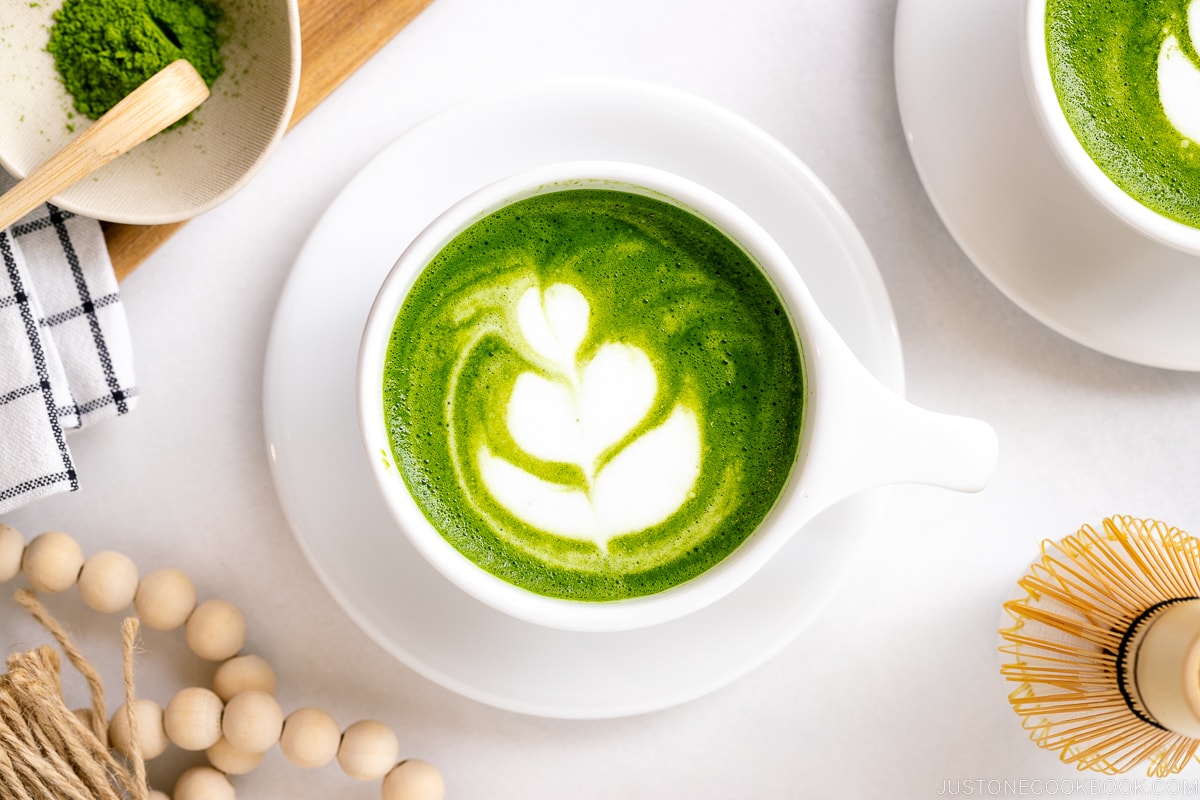 White cups containing Matcha Latte with a turip latte art.