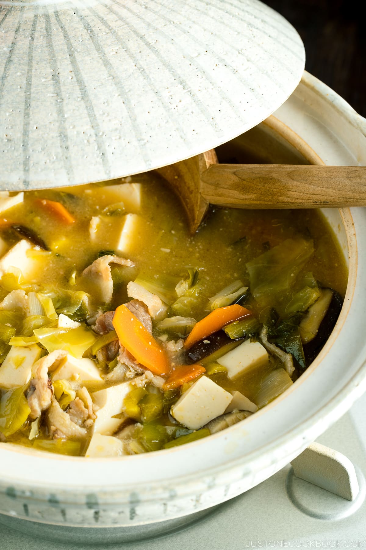 A donabe clay pot containing miso soup.