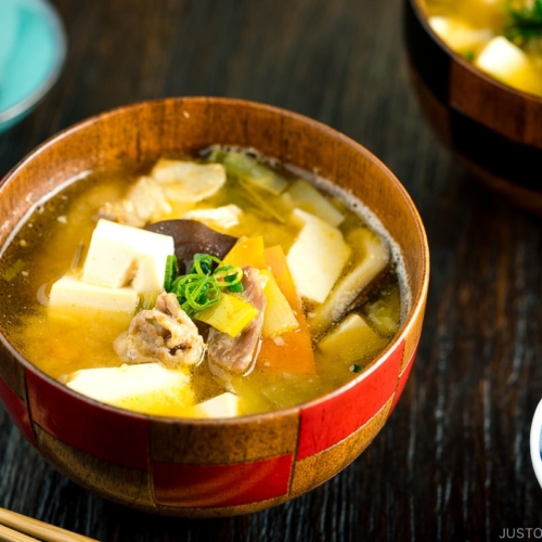 A wooden soup bowl containing miso soup.