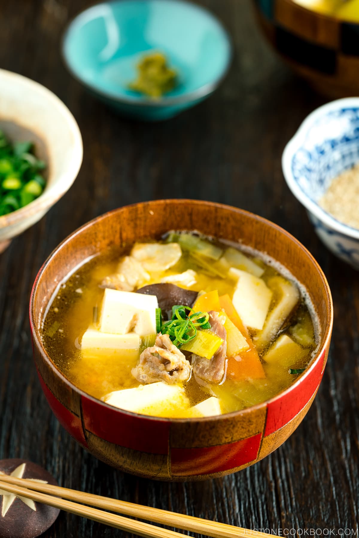 A wooden soup bowl containing miso soup.