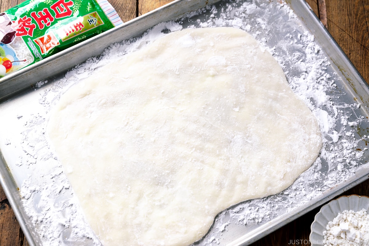 A baking sheet containing a sheet of Gyuhi (Japanese soft mochi dough).