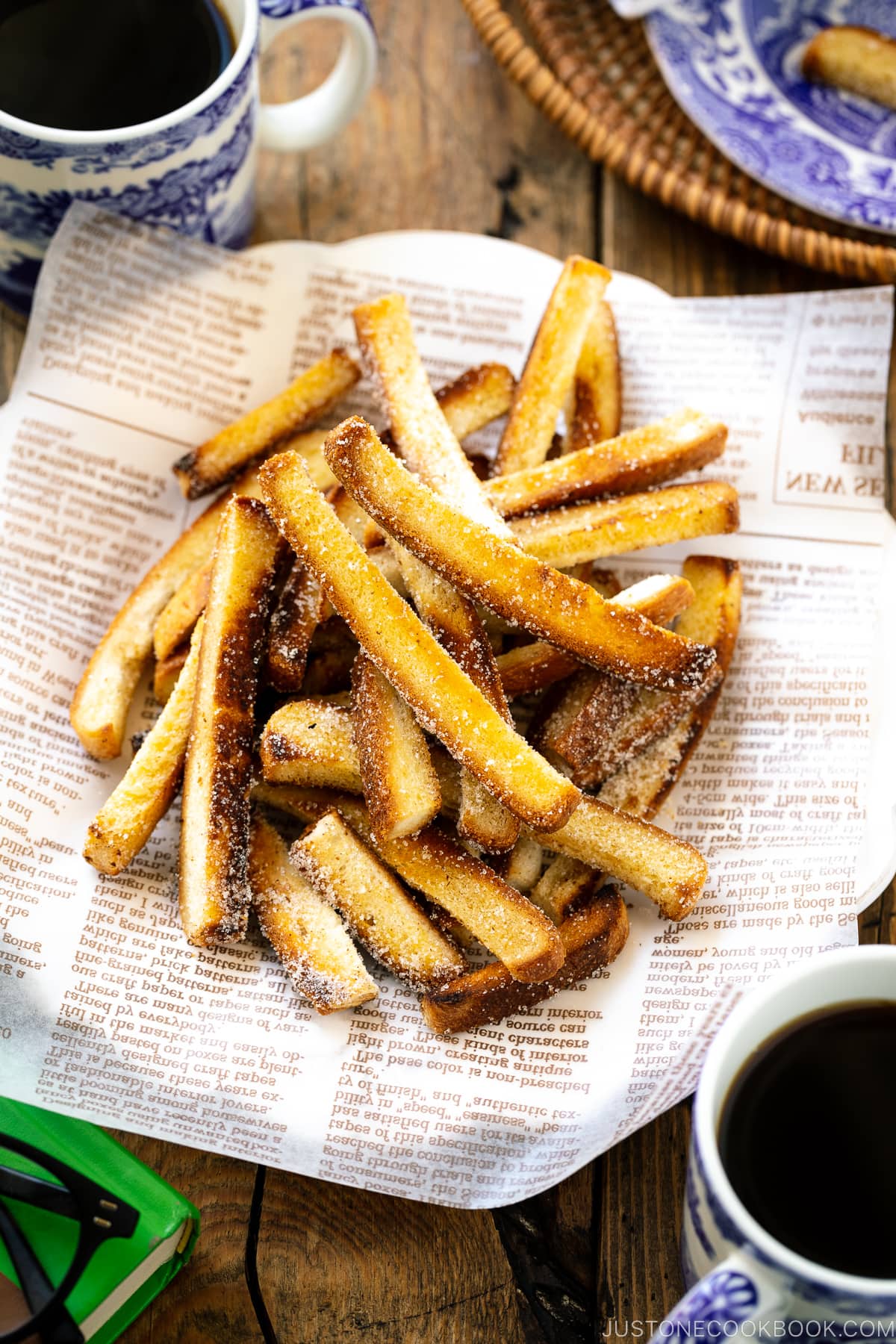 A plate containing Shokupan Crust Rusk, pan-fried crust from Japanese milk bread coated with sugar.