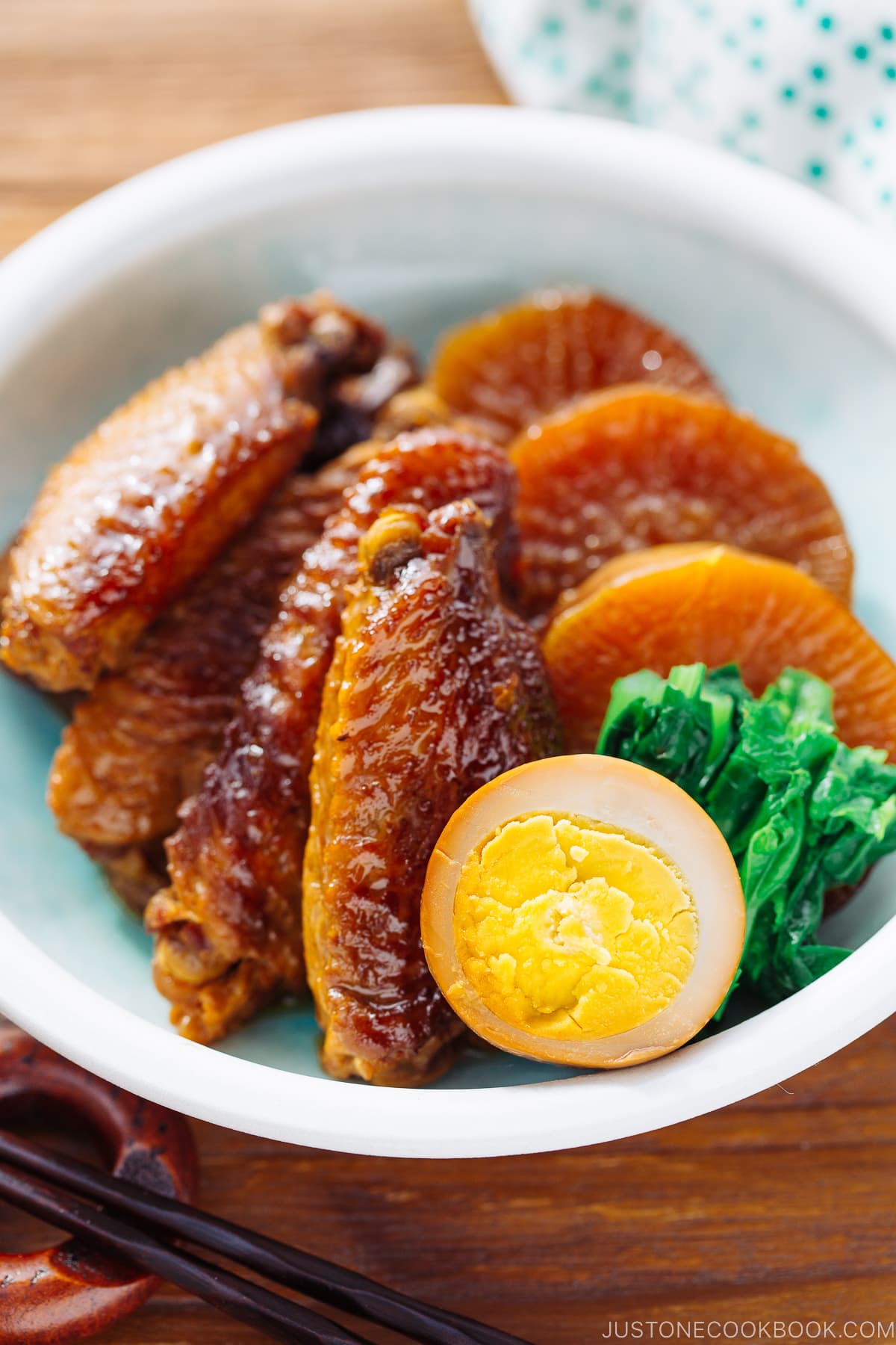 A plate containing slow cooker chicken wings along with daikon and eggs.