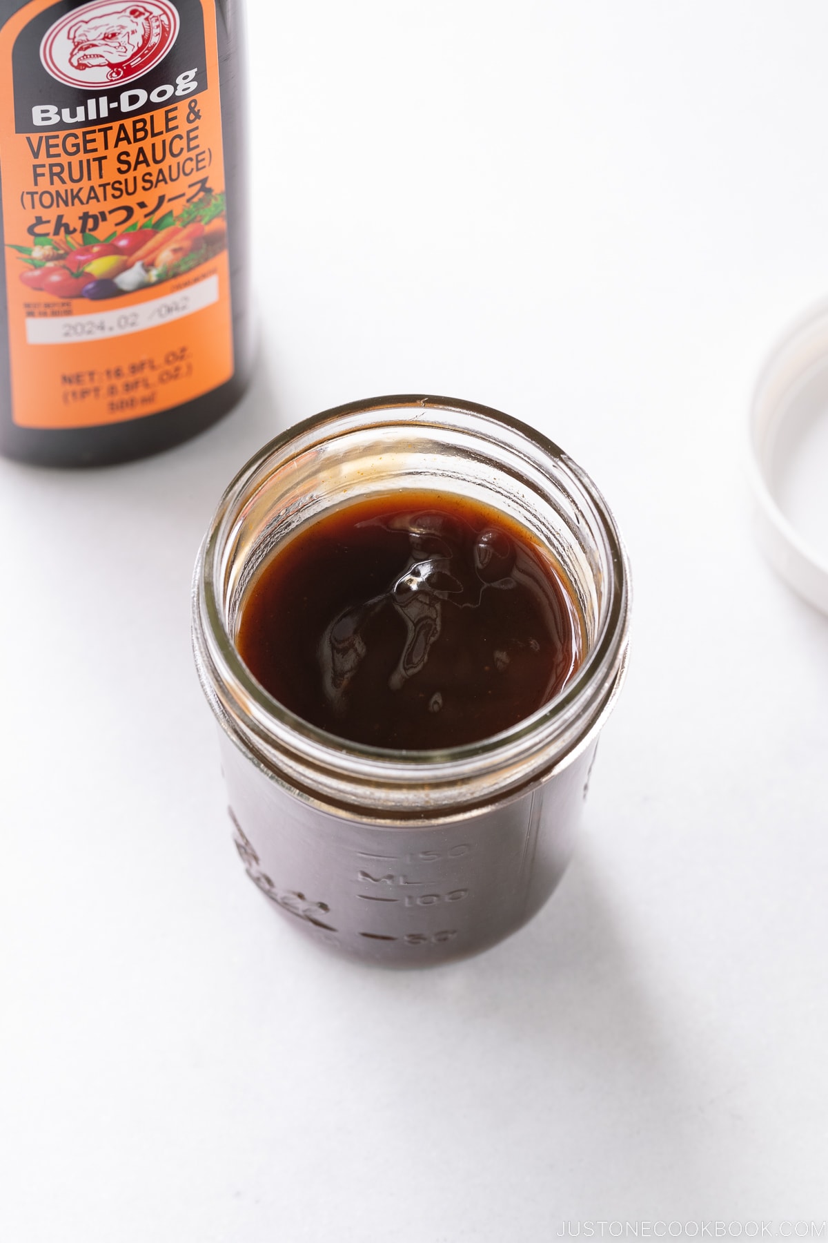 A Bull-Dog Vegetable Fruit Sauce (Tonkatsu Sauce) and homemade tonkatsu sauce in a mason jar.