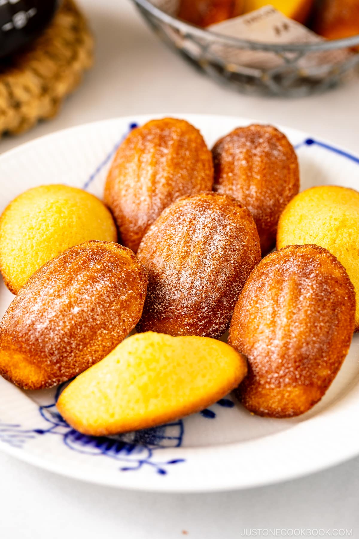 A Royal Copenhagen plate containing Madeleines dusted with powdered sugar.