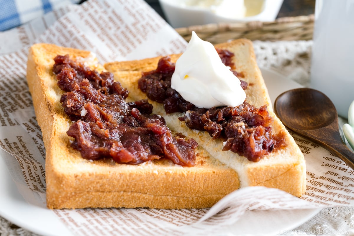 A Japanese shokupan toast topped with butter, sweet red bean paste, and fresh whipped cream.