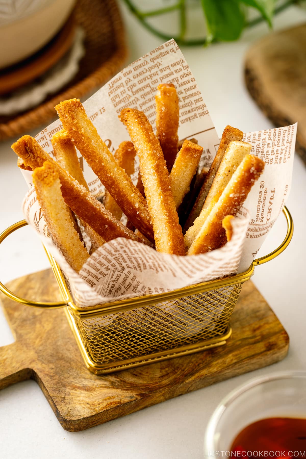A golden mini basket containing oven baked Shokupan Crust Rusks.