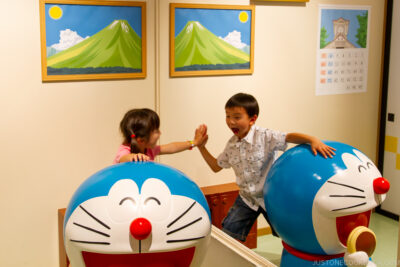 a boy and a girl in doraemon room