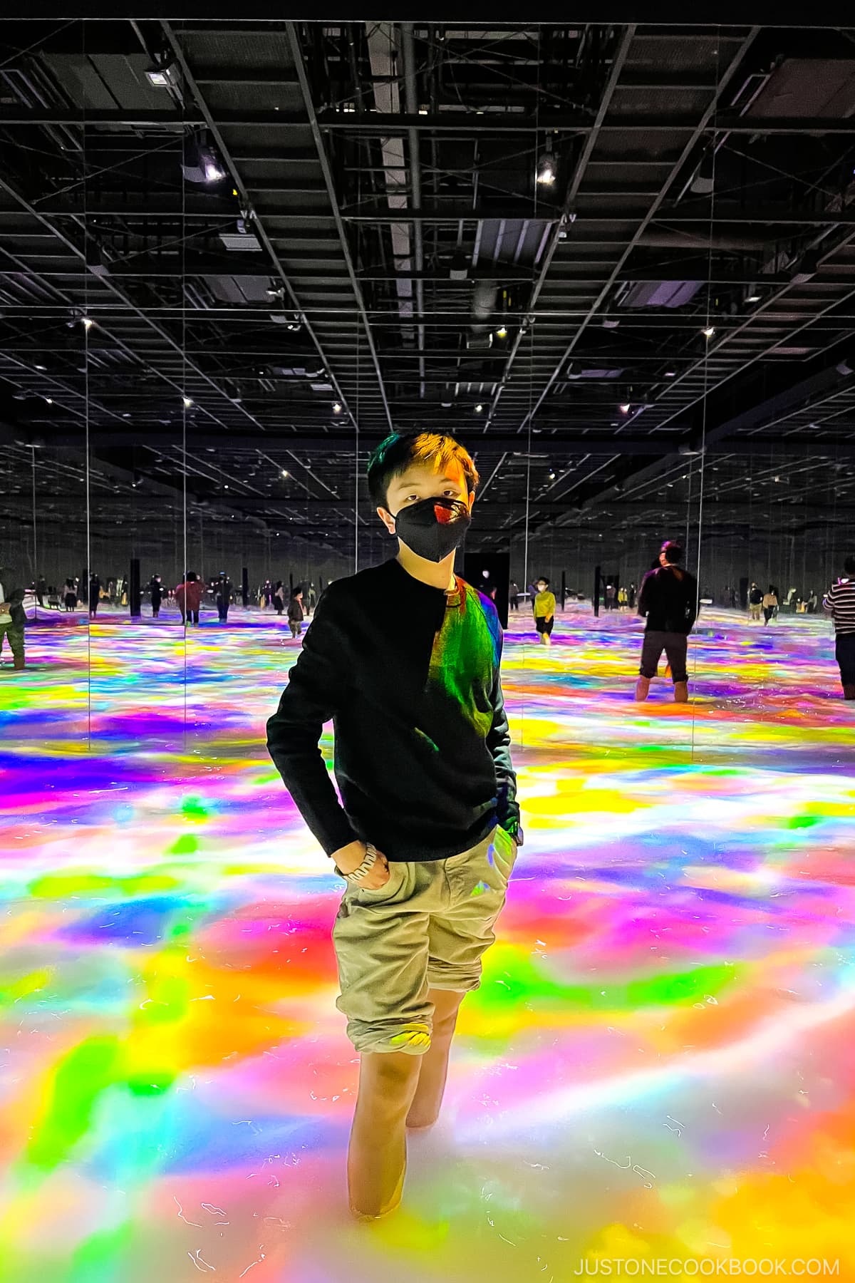 a boy standing in Drawing on the Water Surface Created by the Dance of Koi and People - Infinity