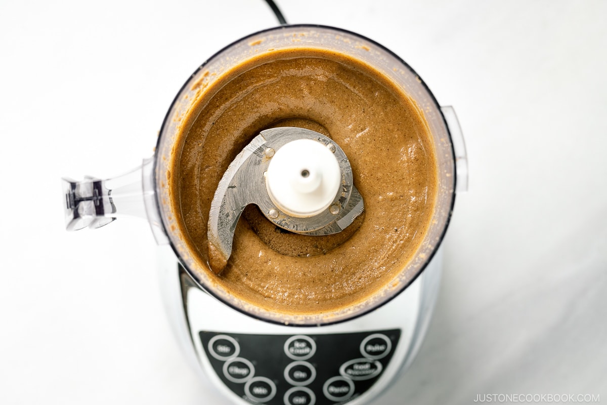 A food processor containing freshly ground Nerigoma (Japanese white sesame paste).