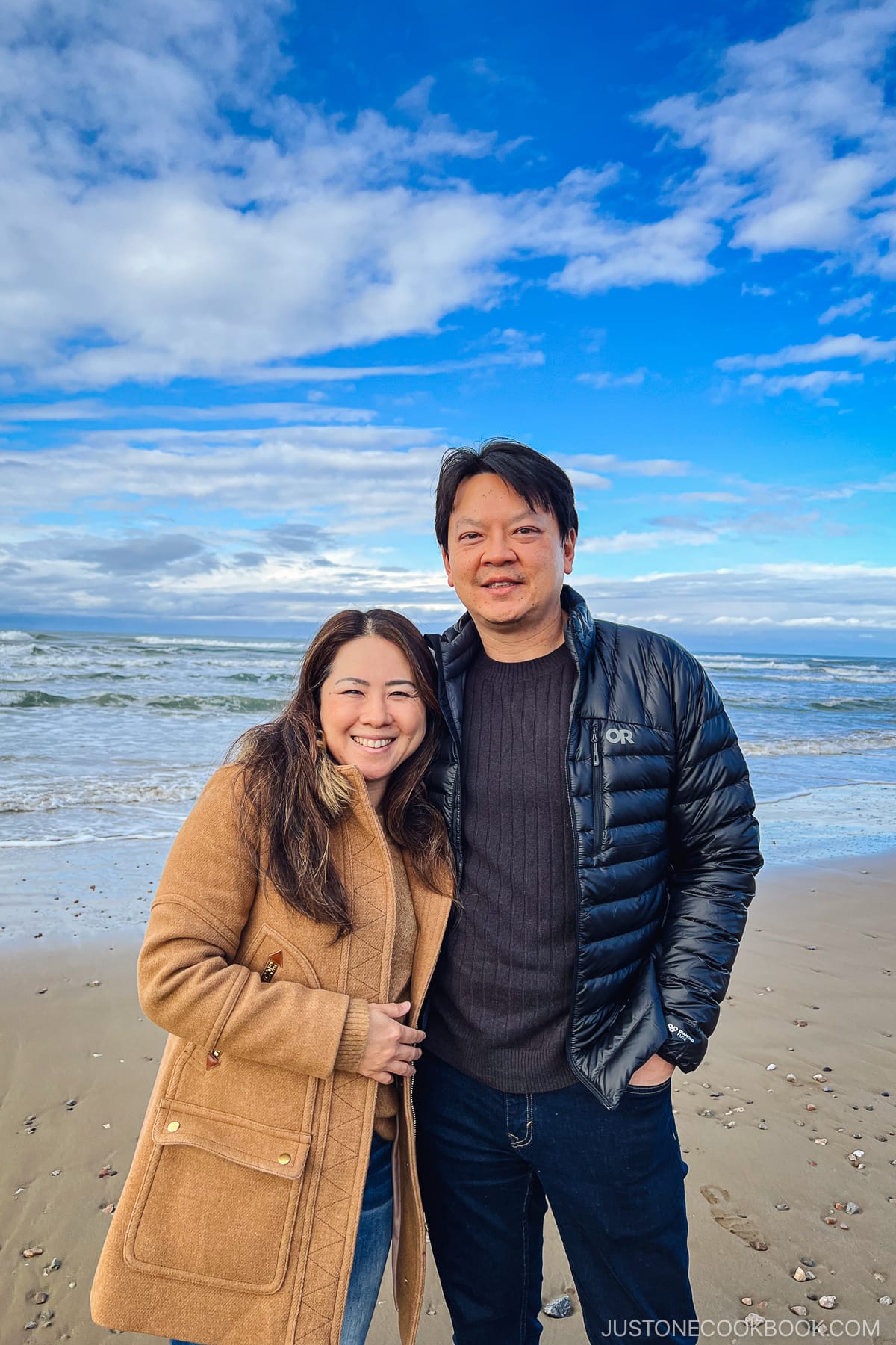 a man and a woman standing on a beach