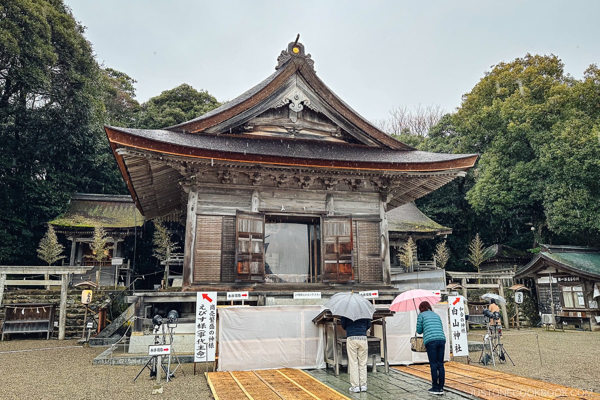 people praying in front of a shrine