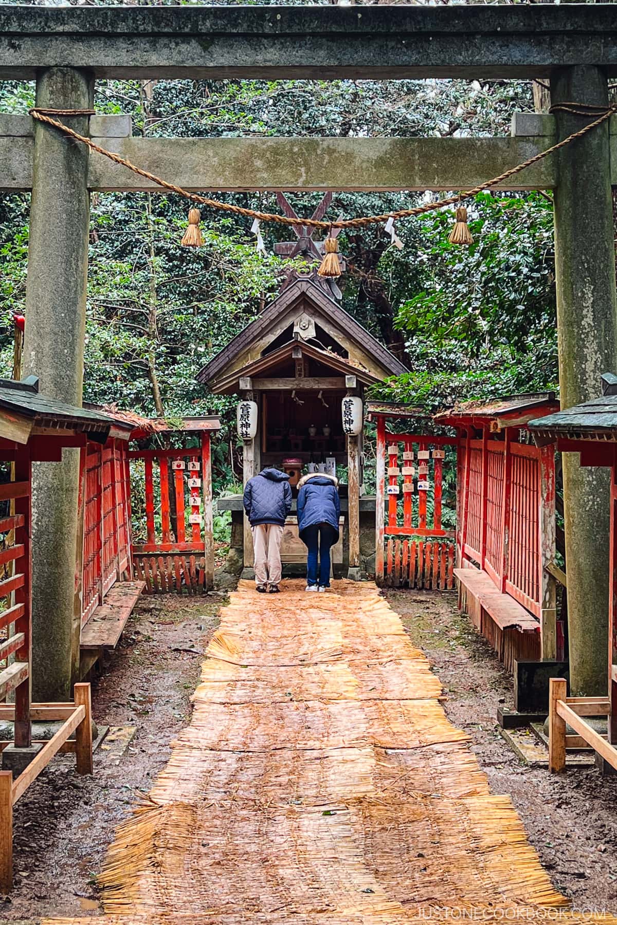 people praying at a small shrine