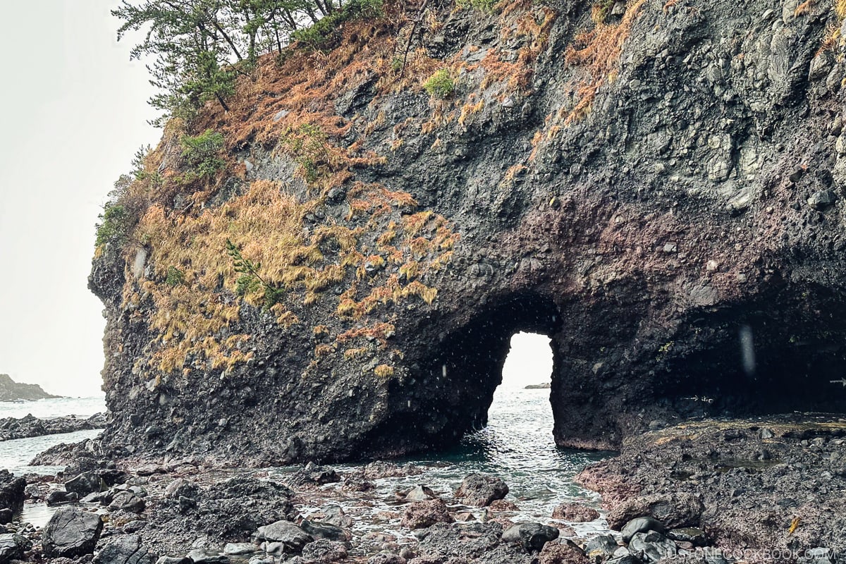 a large gap at the bottom of a large rock