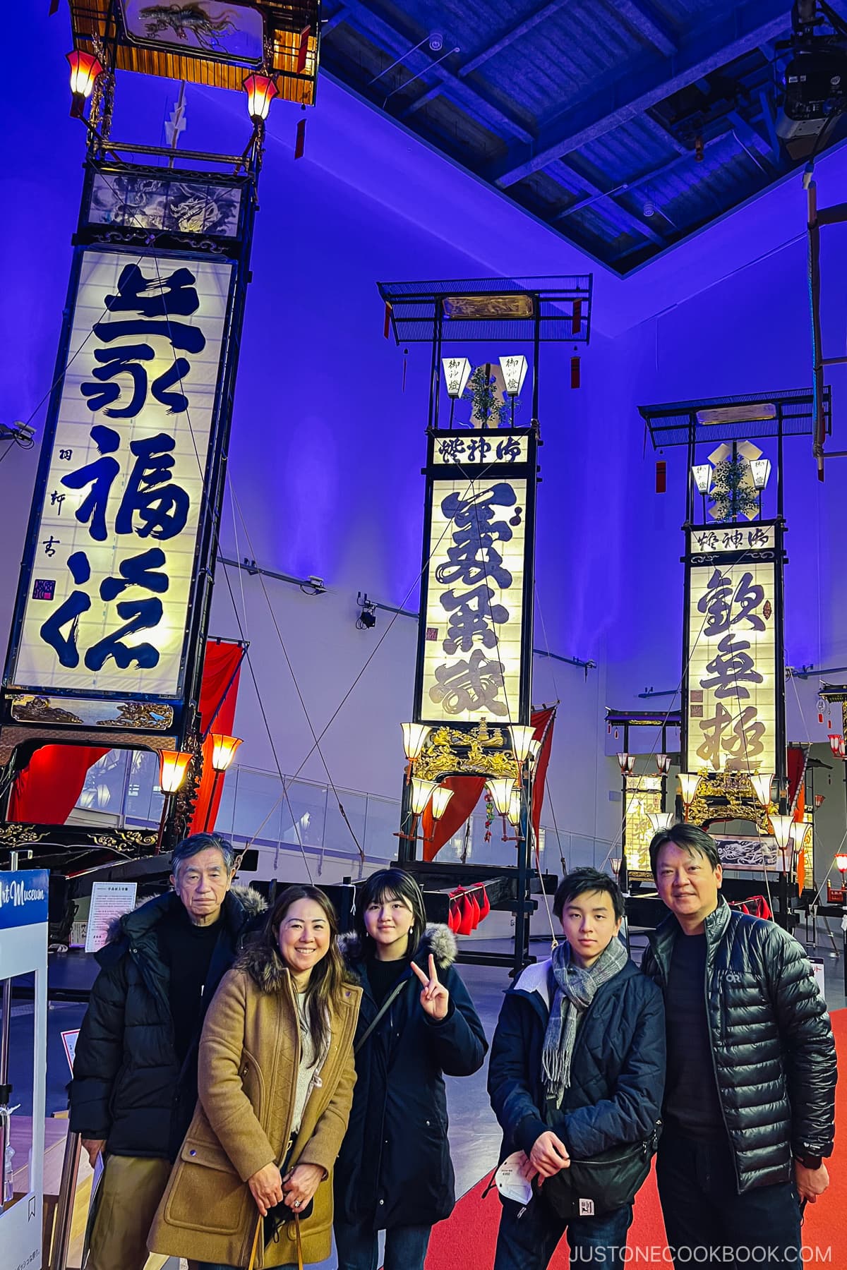 five people standing in front of Wajima Kiriko lanterns