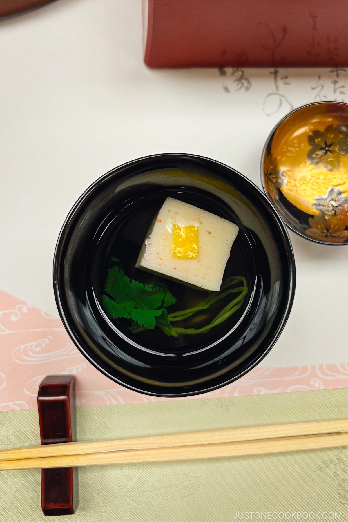 soup served in a black lacquer bowl