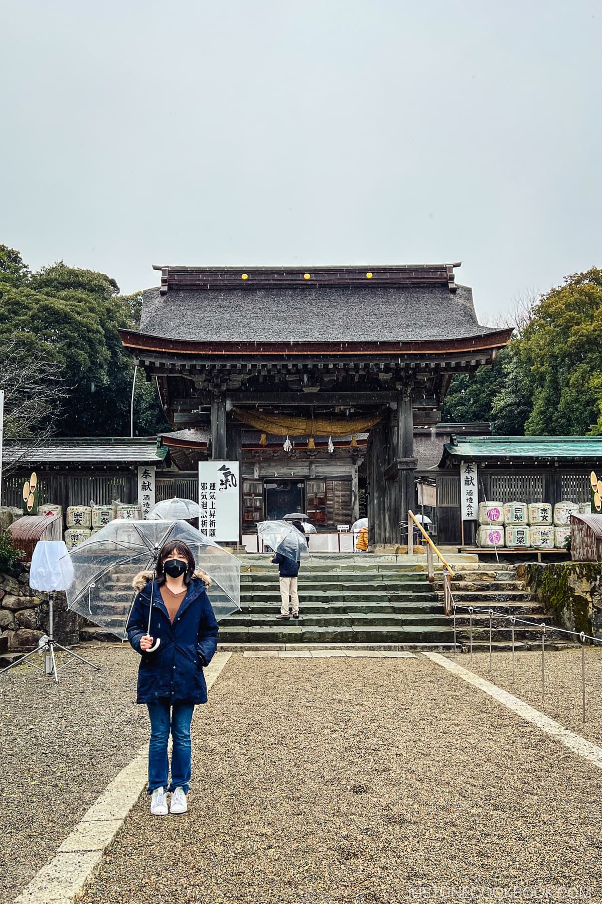 a girl standing in front of a shrine