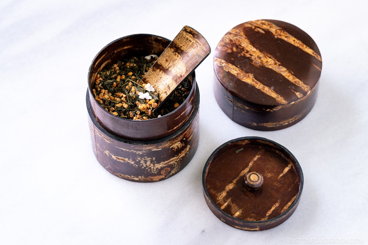 genmaicha tea leaves in a wooden tea container