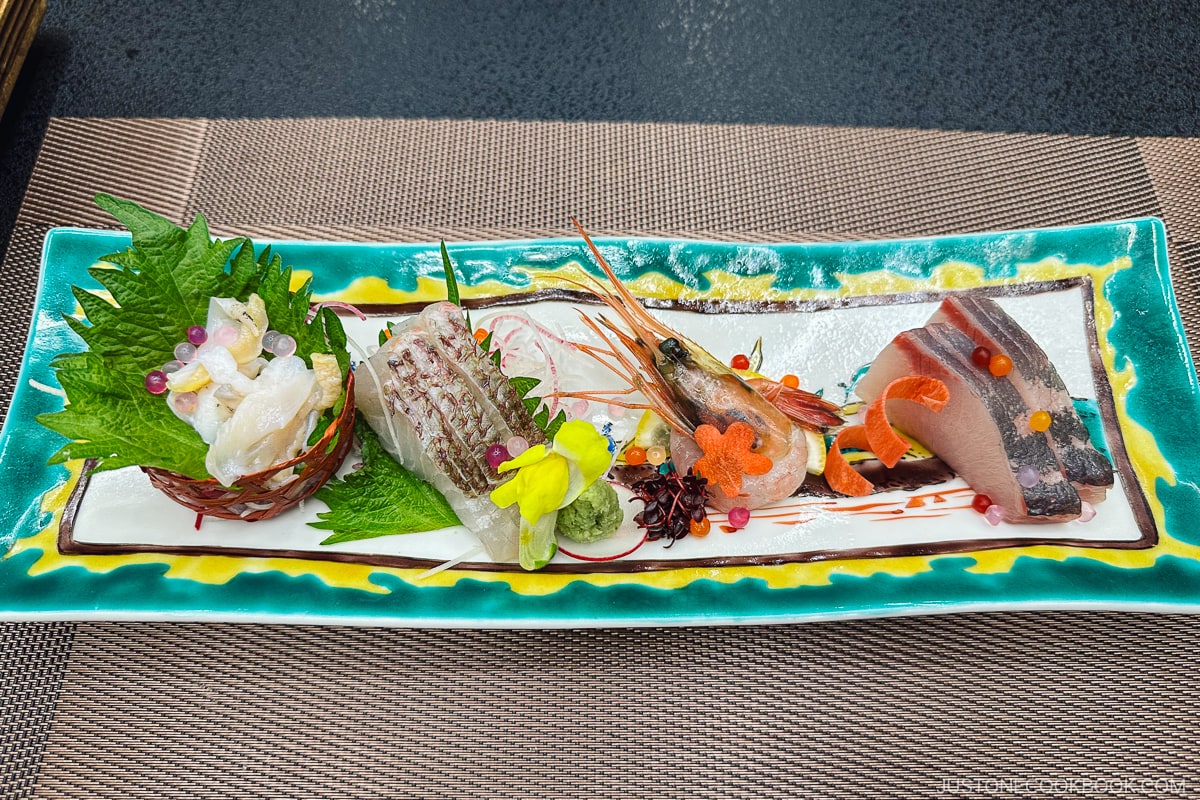 assorted sashimi on a rectangular porcelain plate