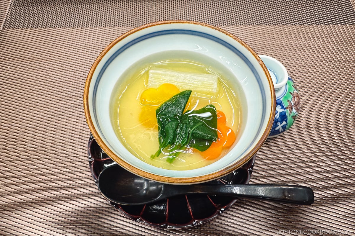 clear soup in a colorful porcelain bowl