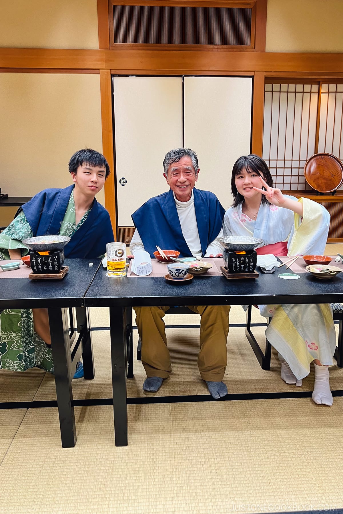 3 people sitting next to a dining table