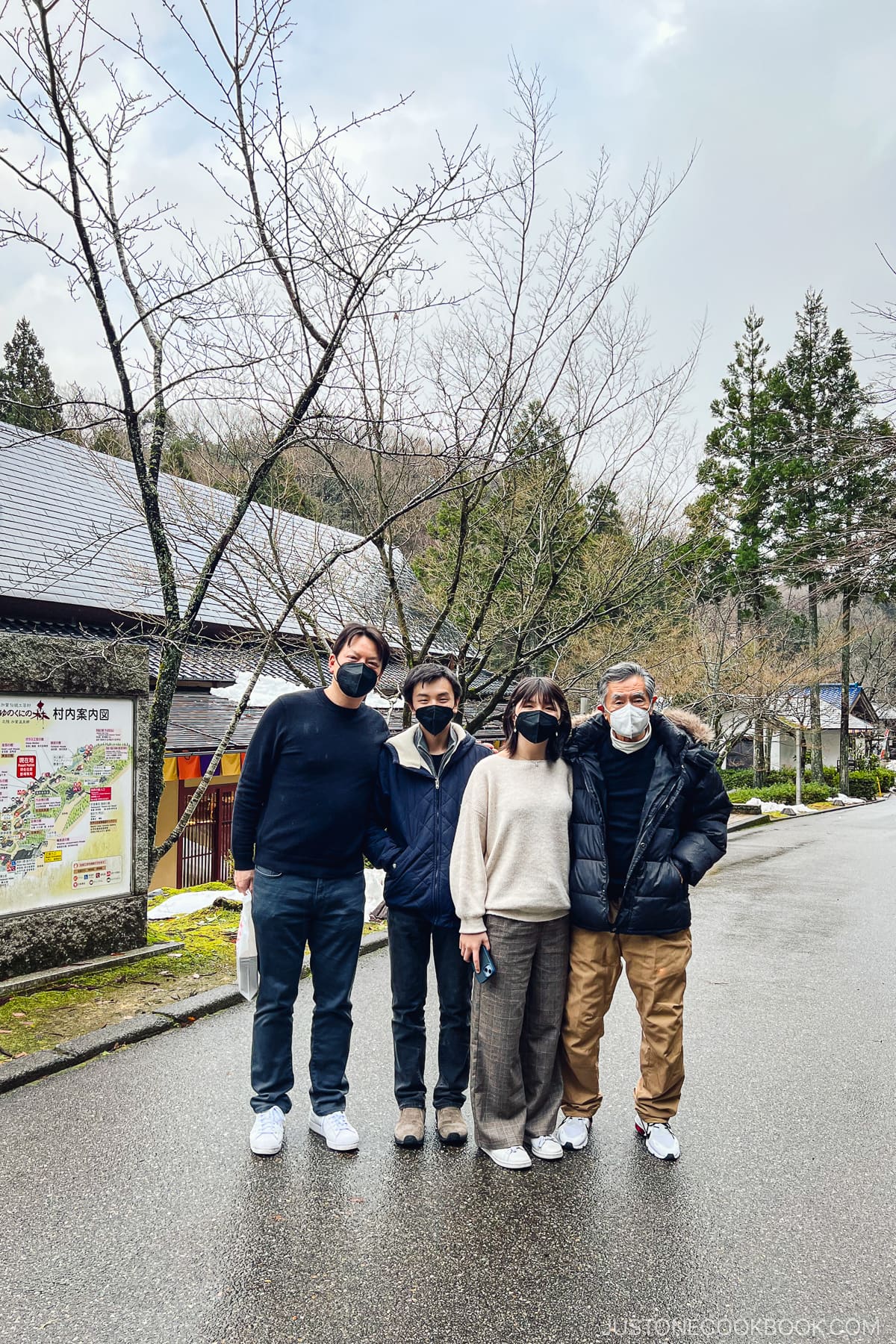 4 people standing on a paved road