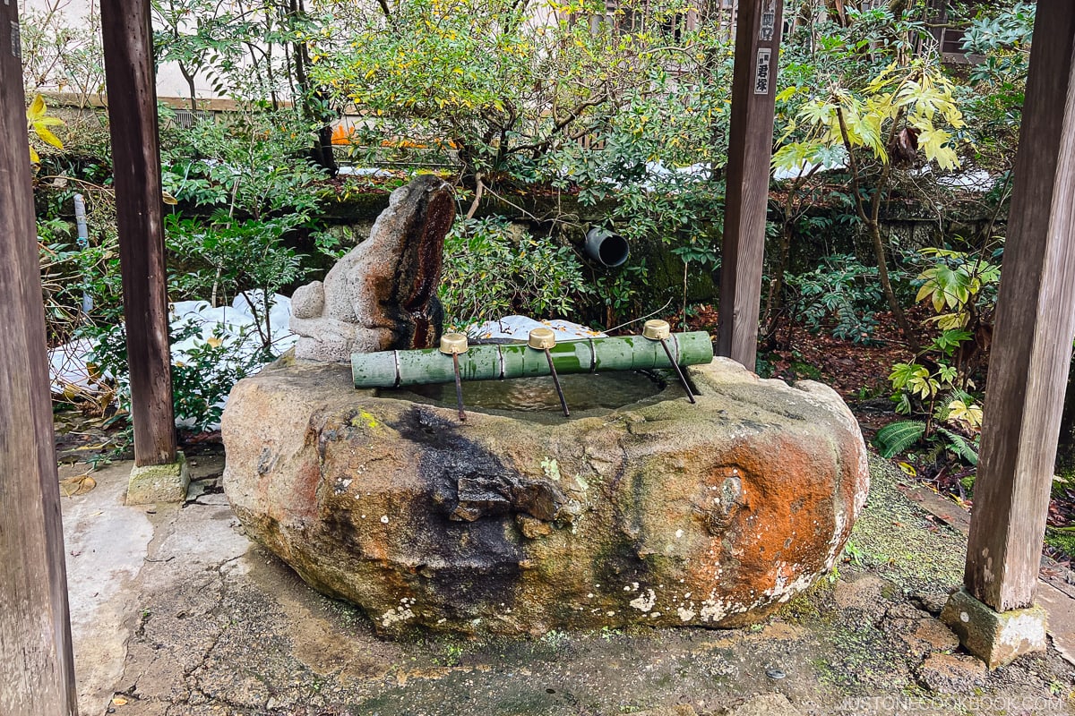 ladles on a rock with spring water