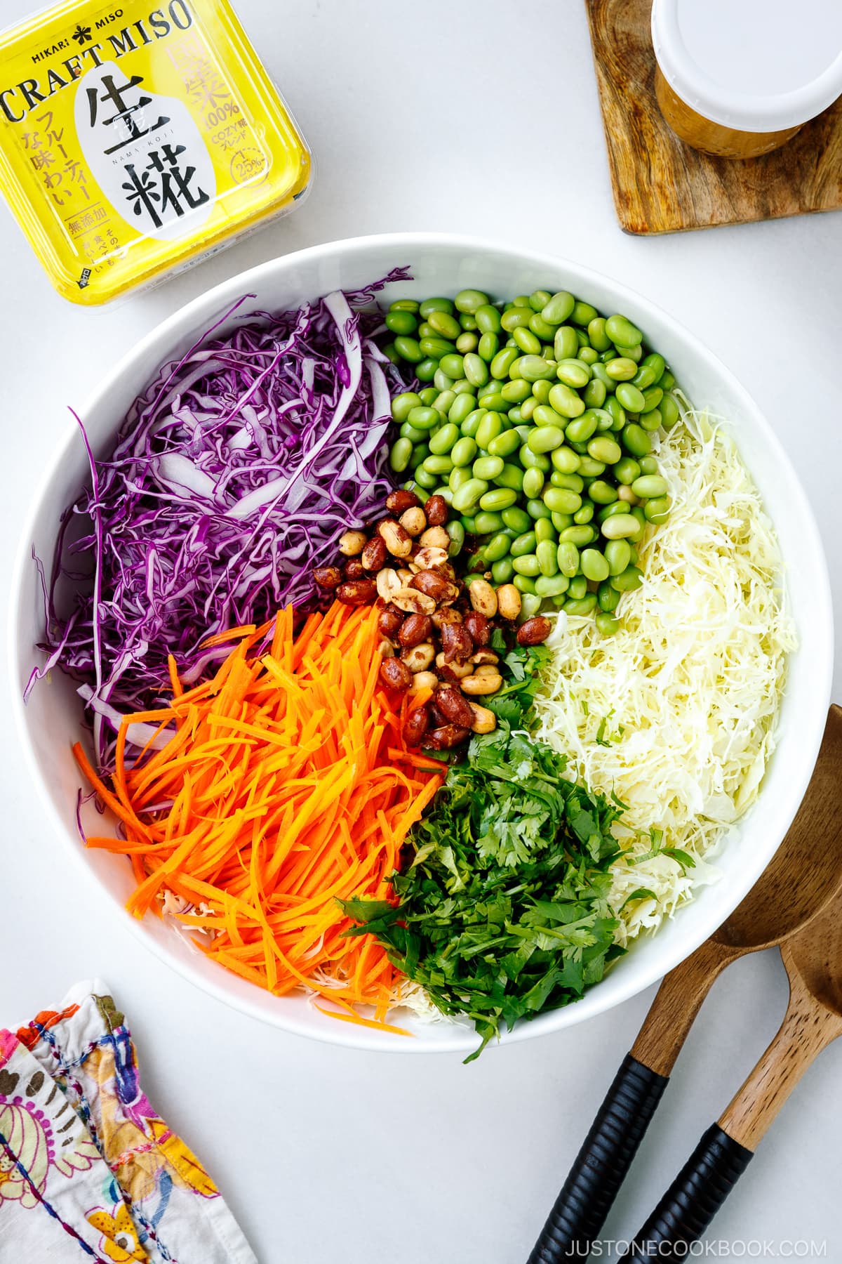 A large salad bowl containing various ingredients for Asian Cabbage Salad.