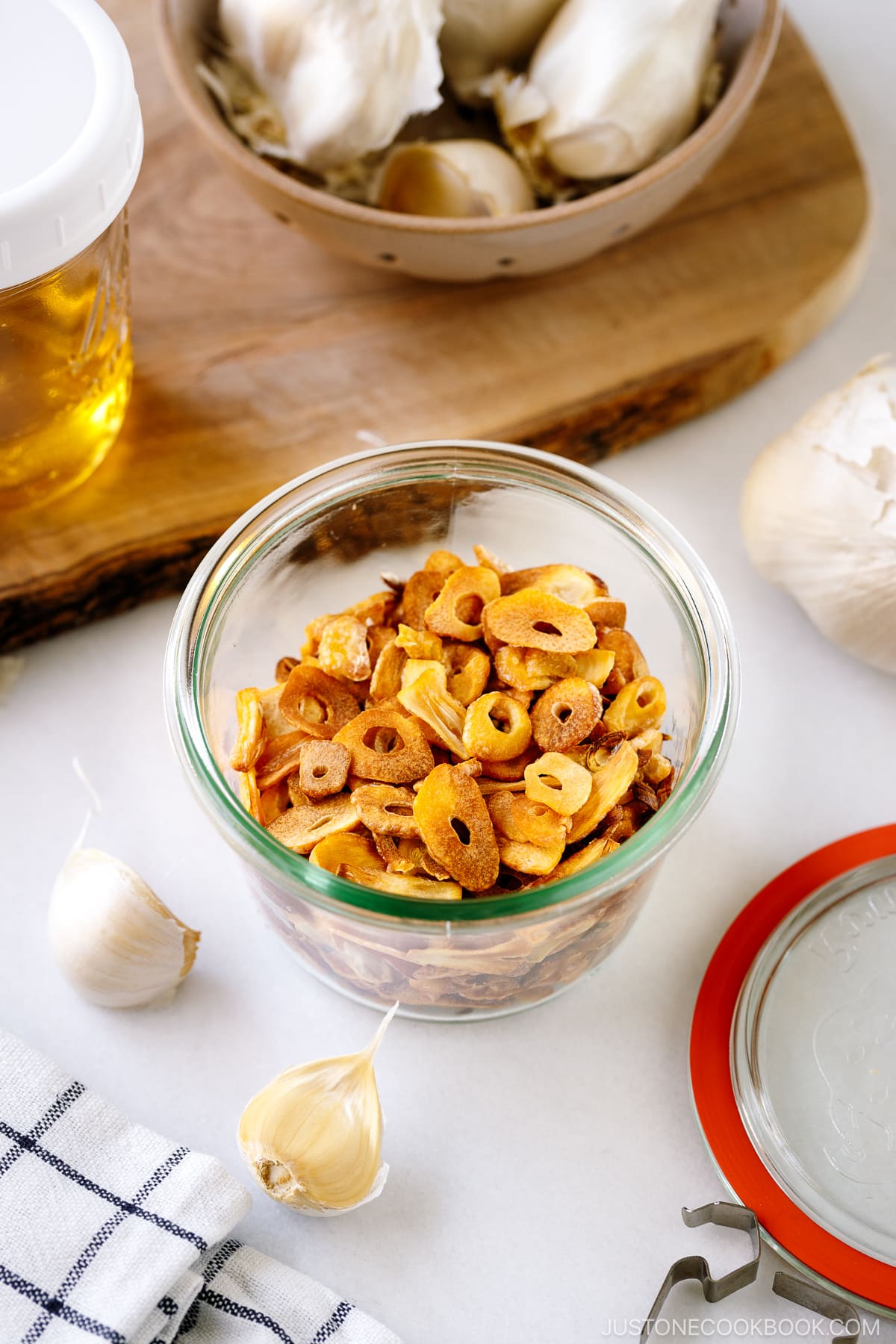 A Weck jar containing golden fried garlic chips.