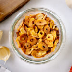 A Weck jar containing golden fried garlic chips.