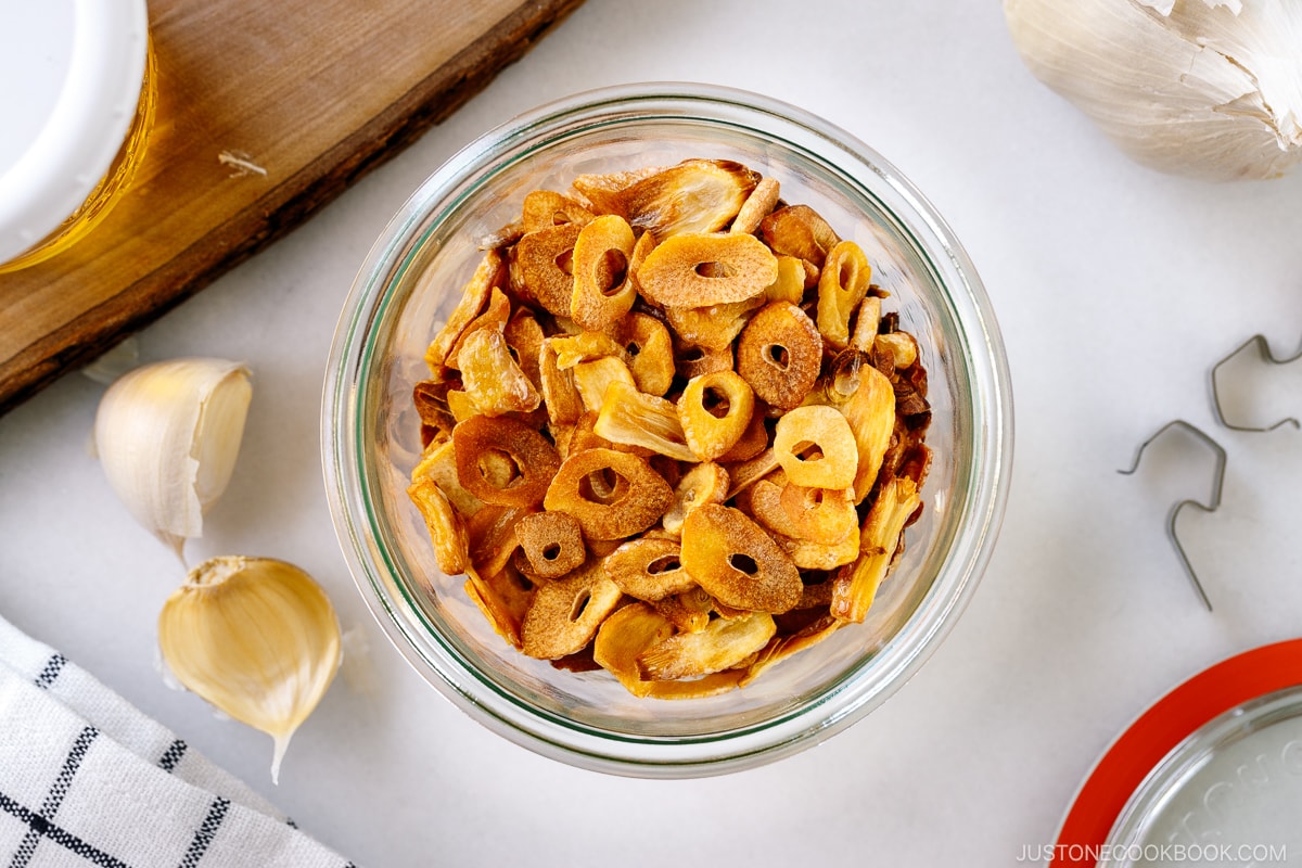 A Weck jar containing golden fried garlic chips.