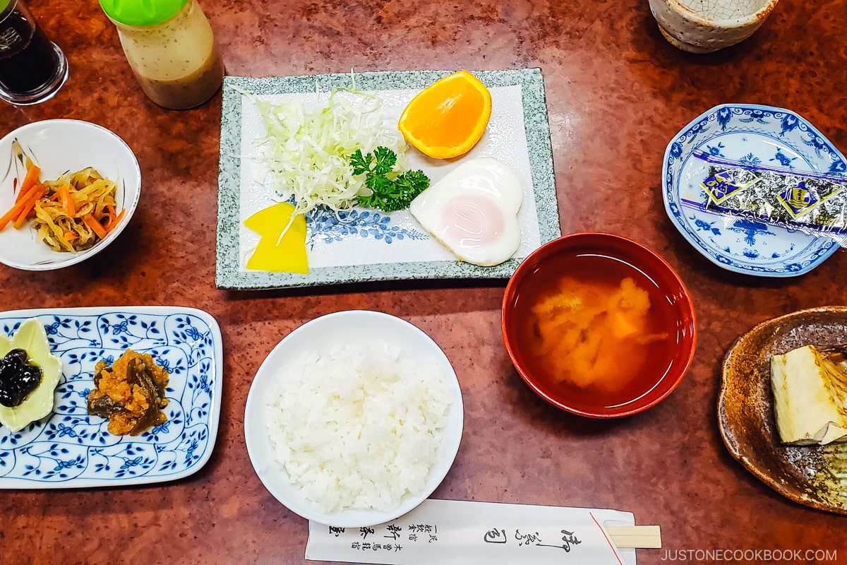 rice, miso soup, and small dishes on a table