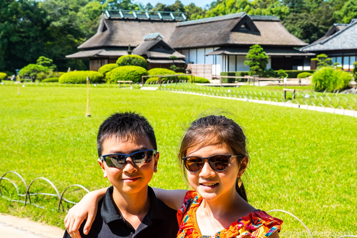 two children in front of a patch of field