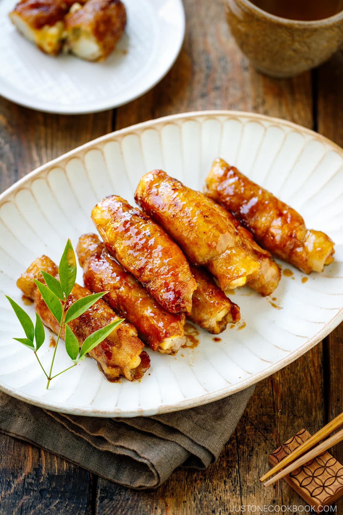 A white oval plate containing Potato Salad Pork Rolls.