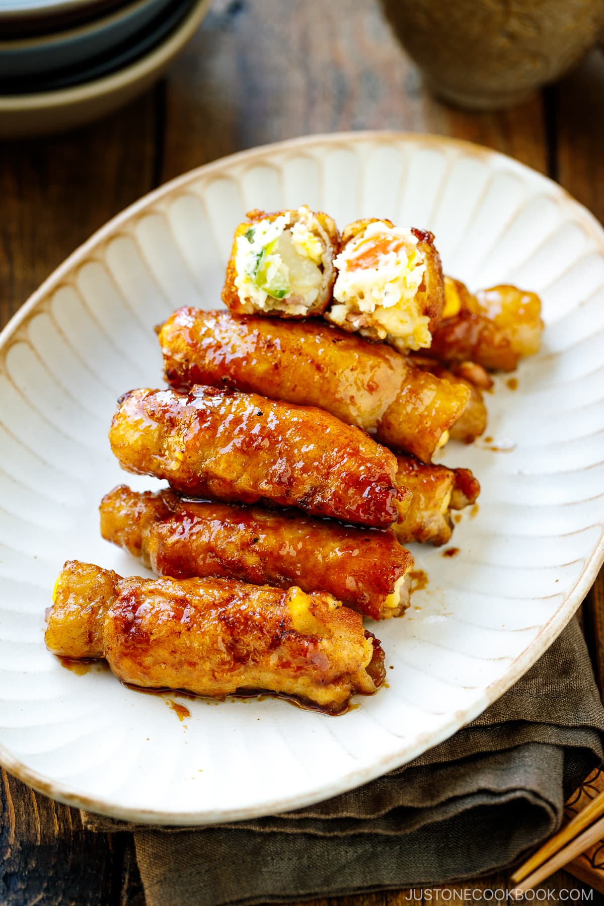 A white oval plate containing Potato Salad Pork Rolls.